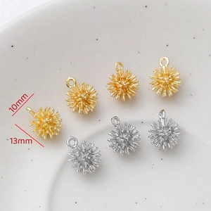 Detailed macro view of 10mm 14k gold and silver urchin pendants for DIY jewelry