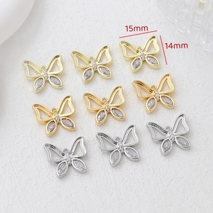 Macro shot of gold and silver butterfly pendants with marquise cubic zirconia 15x14mm