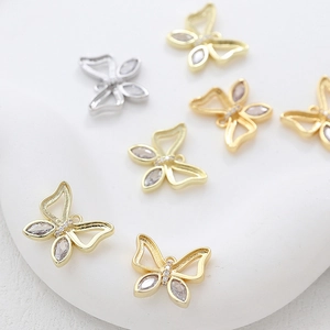 Macro shot of 14k gold butterfly pendants with inlaid zircons for DIY jewelry making