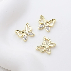 Detailed view of 14k gold-plated butterfly charms with zircon inlays for DIY jewelry