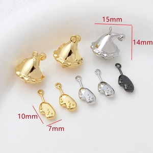 Macro view of 14k gold-plated Christmas hat and glove pendants for DIY jewelry