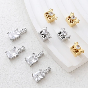 Macro shot of 14k gold plated heart zircon pendants and geometric jewelry charms