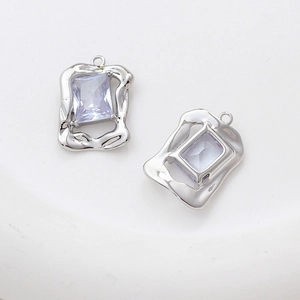Macro detail of irregular silver liquid metal pendant with faceted lavender zircon stone