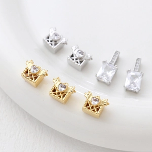 Macro shot of 14k gold plated heart zircon pendants and emerald-cut crystal charms