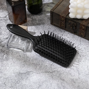 Black air cushion hairbrush with sun and moon prints for scalp massage and detangling