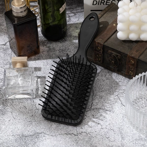 Classic black air cushion hairbrush with cute cat print for long hair detangling on stone base
