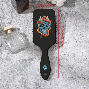 Gothic paddle brush featuring blue skull and orange snake art for detangling hair