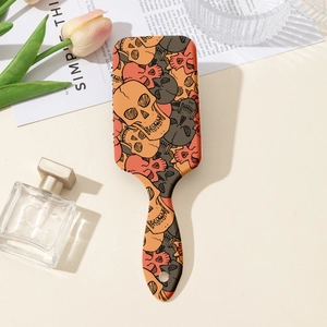 Close-up of hair brush handle with colorful skull pattern and hanging hole detail