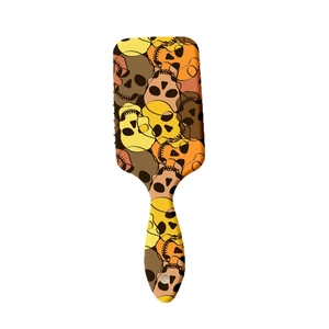 Artistic skull pattern air cushion hairbrush with vibrant yellow and orange graffiti design