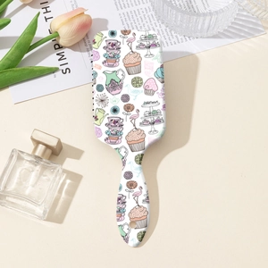 Detailed view of square cushion hairbrush with elegant floral and flamingo pattern print
