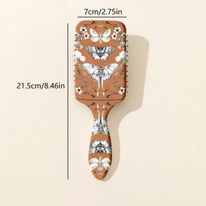 Vue détaillée de la brosse à cheveux avec motif papillon et fleurs, taille 21,5 cm par 7 cm