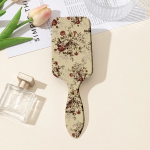 Detail of vintage floral hairbrush with pink tulips and elegant vanity accessories