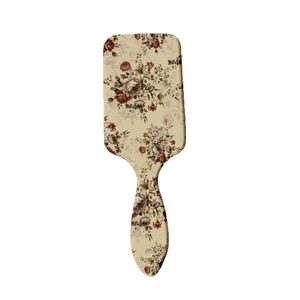 Vintage floral print paddle hairbrush with scalp massage pins and cream-colored handle