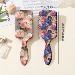 Detail showing vintage oil painting flower patterns on massage air cushion hairbrushes