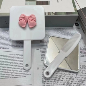 Cute sausage mouth handheld makeup mirror and comb set with pink bow detail in white