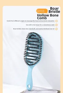 Detail of light blue vented hair brush with boar bristles for styling and scalp massage