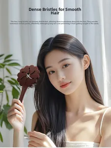 Brown floral hair brush for detangling long hair shown on an Asian female model