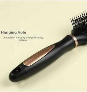 Detail of ergonomic black brush handle with rose gold accents and hanging hole design