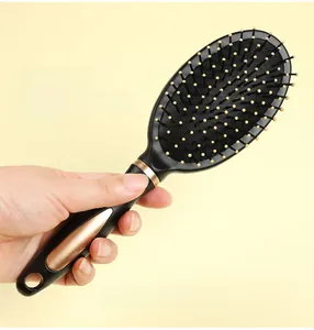 Detail view of large paddle hair brush with yellow tipped bristles and 24cm size spec