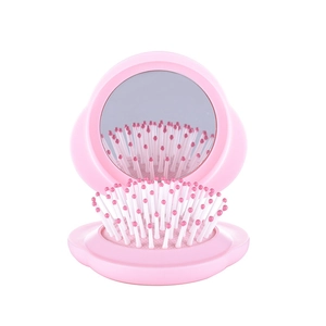 Portable pink folding hairbrush with mirror and massage bristles for daily travel use