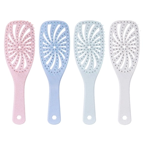 Set of four pastel hollow hairbrushes for scalp massage and blow-dry styling on white background