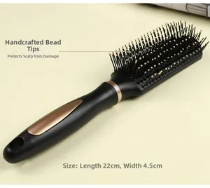 Detail view of black hairbrush with gold-tipped cushion bristles and rose gold trim handle