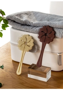 Close-up of cloud-shaped hollow detangling hairbrushes in beige and dark brown colors