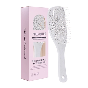 Hollow-out vented hairbrush for volume with pink box on a clean white background