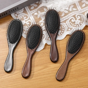 Set of four ergonomic wooden hair brushes with massage air cushions and round pins