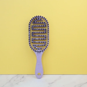 Purple hollow detangling hair brush with flexible vented design and black bristles