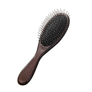 Portable wooden hair brush with massage air cushion and metal pins on white background