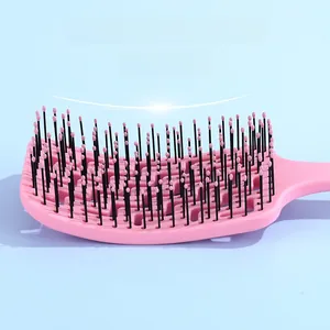 Detail of pink curved detangling hairbrush with flexible bristles and massage bead tips