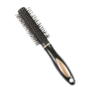 Professional round roller hair brush with black handle and rose gold accent for styling