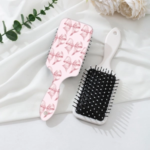 Pink leopard bow massage hairbrush set with air cushion bristles on white silk fabric