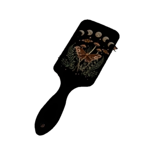 Air cushion hair brush featuring moon phases and butterfly prints on black rectangle base