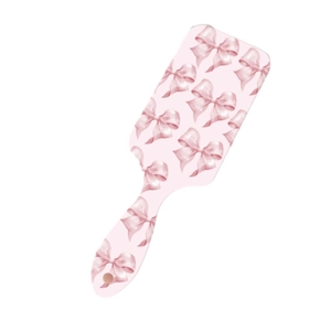 Professional pink paddle brush with bow print for scalp massage and smooth hair styling