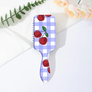 Detail of square air cushion hairbrush with purple checkered cherry print on white silk