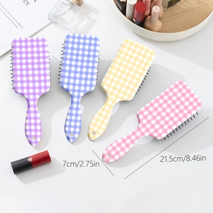Set of four checkered air cushion hair brushes in purple, blue, yellow, and pink colors