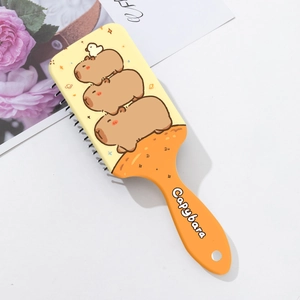 Detail of Capybara printed hairbrush with massaging air cushion and ergonomic handle