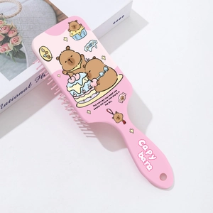 Detailed view of pink Capybara hairbrush with massage bristles and cute cartoon prints