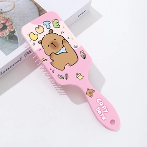 Detail of pink Capybara massage hairbrush with cute cartoon print and soft bristles