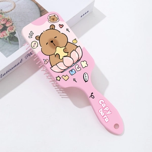 Detail of pink Capybara massage hairbrush with flexible bristles and cute cartoon print