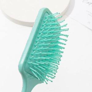 Floral air cushion hair brush in mint green for scalp massage and hair smoothing