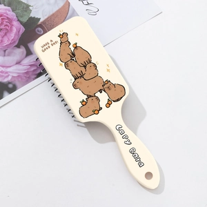Detail of Capybara printed hairbrush with air cushion massage bristles and hanging hole