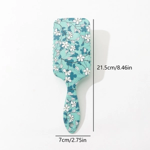 Floral print air cushion hair brush in light green with scalp massaging bristles