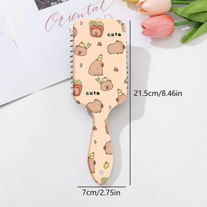 Detail view of a beige Capybara air cushion massage hairbrush with size dimensions
