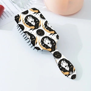 Artistic star and moon illustration on the back of a white paddle hairbrush for women