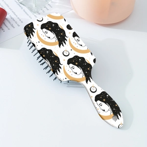 Detail of white air cushion hairbrush featuring retro moon and star female print design