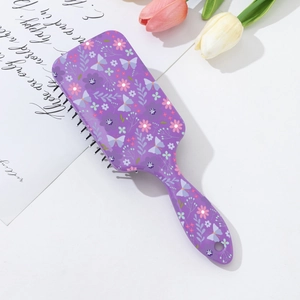 Detail of floral print on the rectangular purple air cushion massage hairbrush