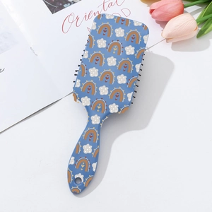 Detail of bohemian printed paddle brush with massaging air cushion and cartoon patterns